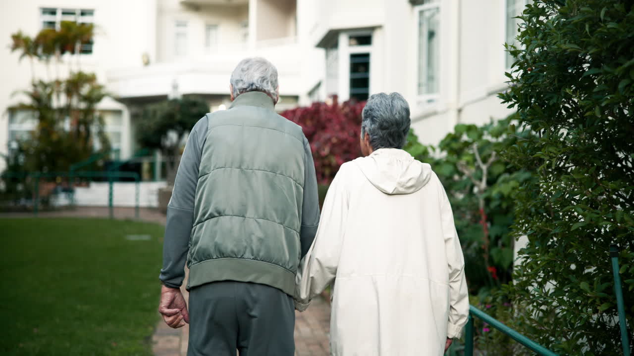 Elderly couple walking together in a park