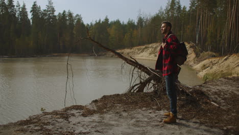 Man-traveling-relaxing-alone-with-river-canyon-view.-Man-survival-traveling-hiking-at-river-active-healthy-lifestyle.-High-quality-4k-footage