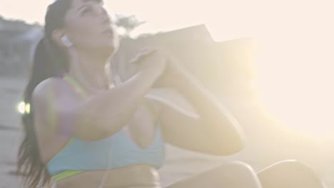 sporty woman doing crunches on beach