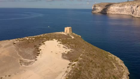 Drone-shot-behind-Xlendi-Tower-in-Gozo