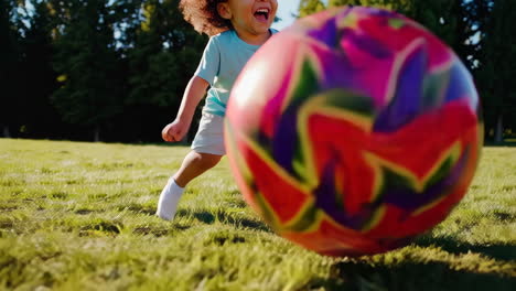 child playing with a ball in a park