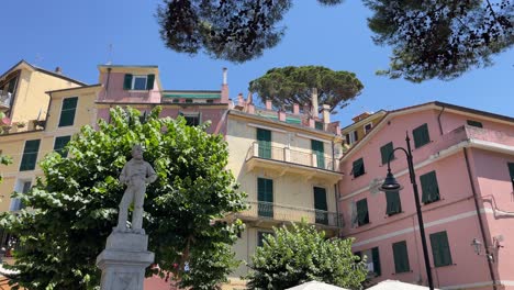 monterosso al mare, italy established shot of colourful traditional architecture house with plant and sculpture in public park