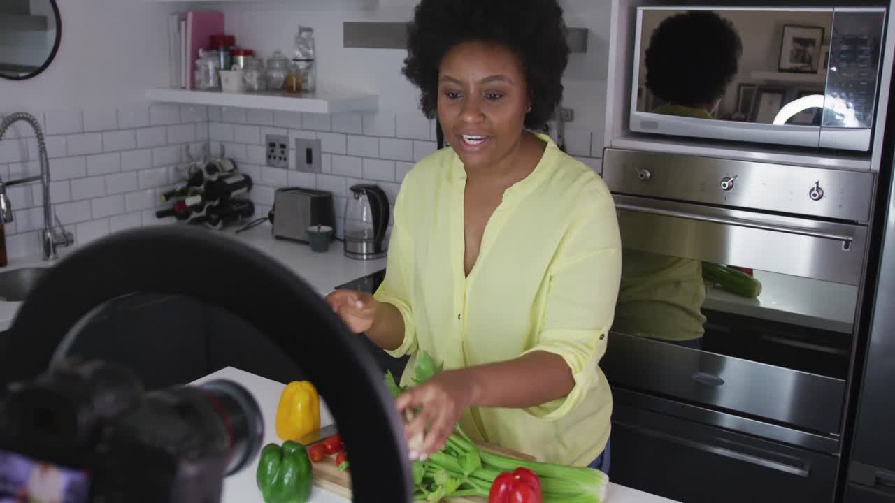 African american female plus size vlogger recording a video about cooking
