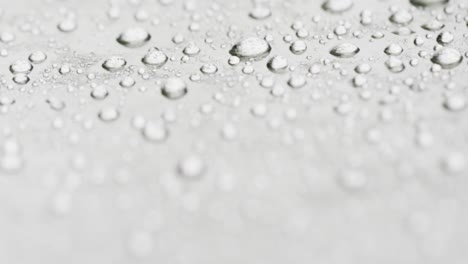 micro video of close up of water drops with copy space on grey background