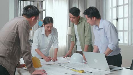 group of asian engineers discuss about work at the office