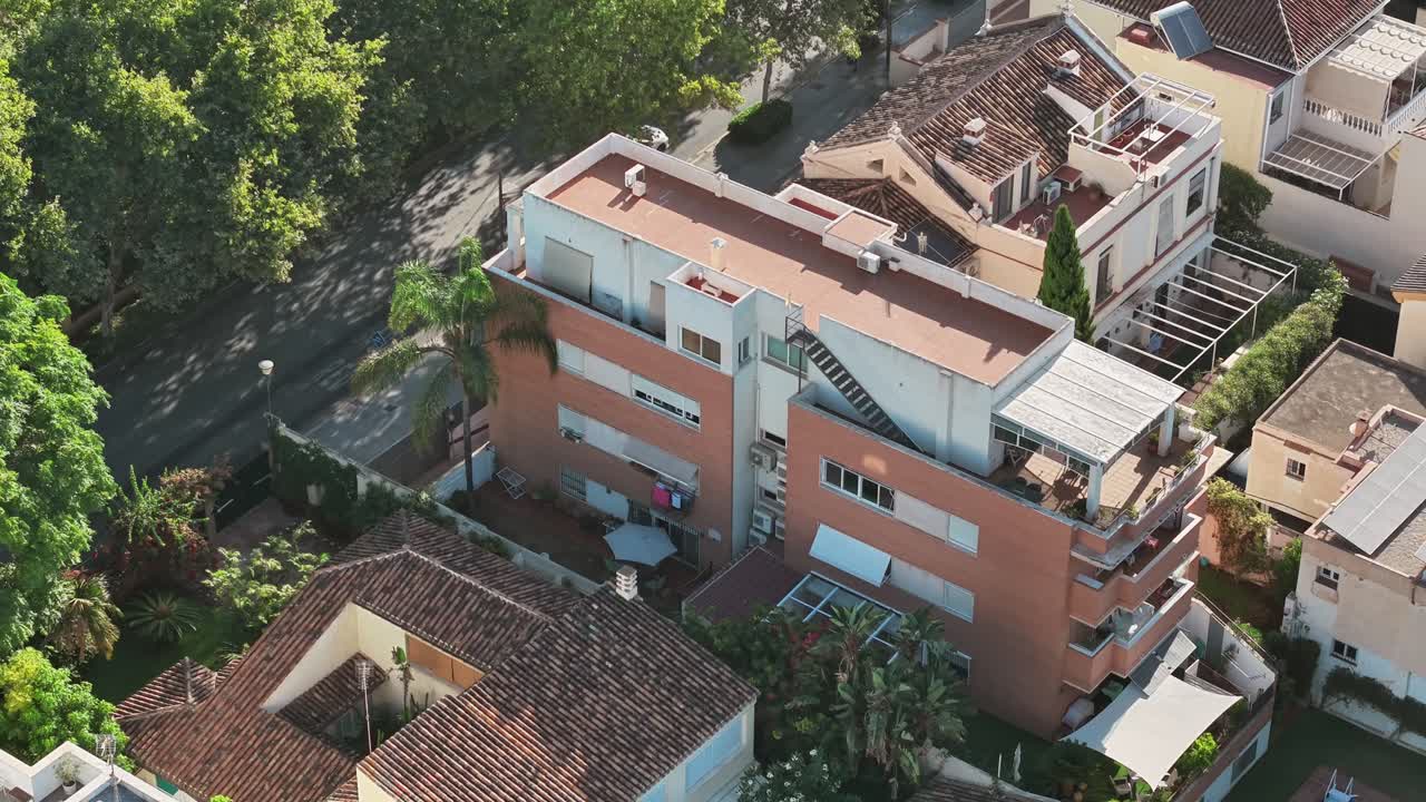 Residential apartment building with balconies in Málaga, Spain, viewed from a drone