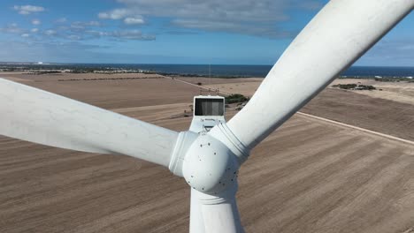 very close orbiting shot of wind turbines spinning