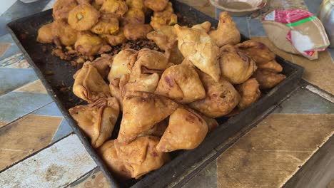 a famous indian street snack food samosa and vada on the stall