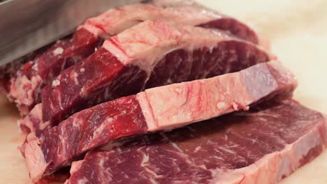 chef cutting angus beef meat for steaks