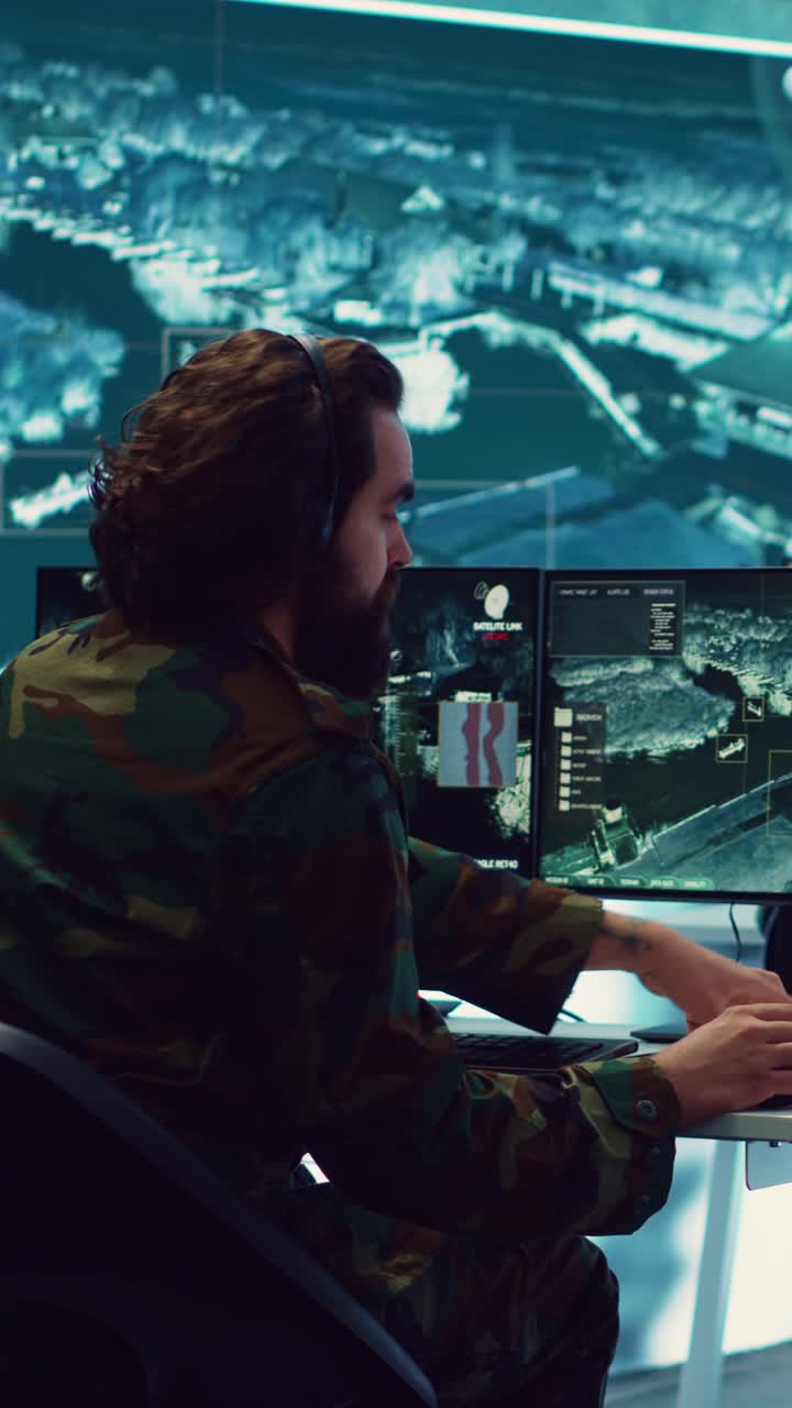 Military Operator Monitoring Satellite Data in High-Tech Control Room