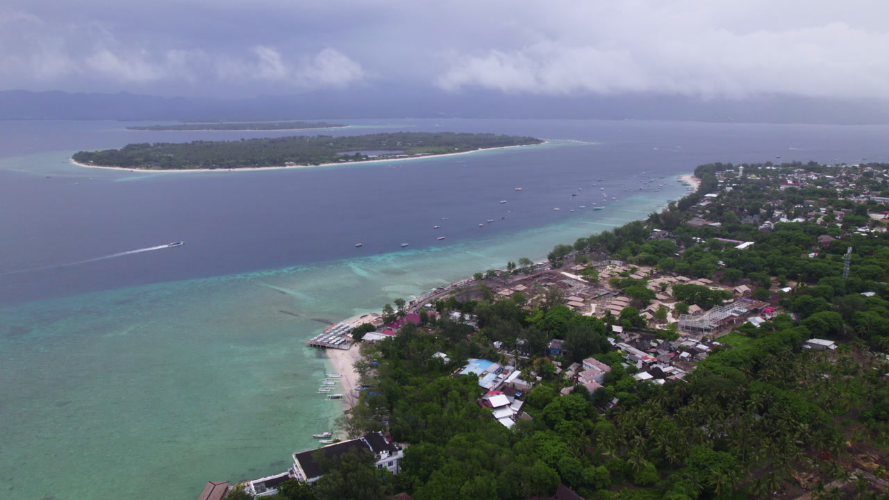 Establishing drone shot of the Gili Trawangan islands, in cloudy Lombok, Indonesia