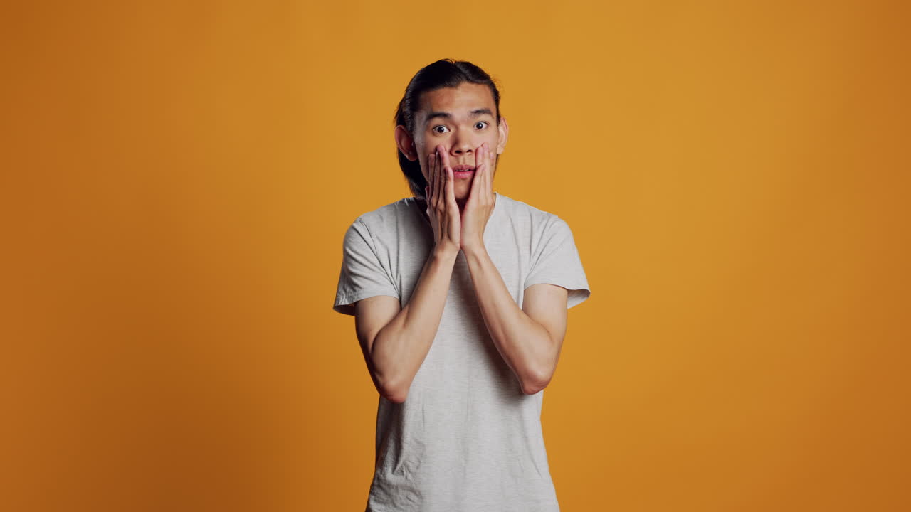 Shocked amazed person covering open mouth