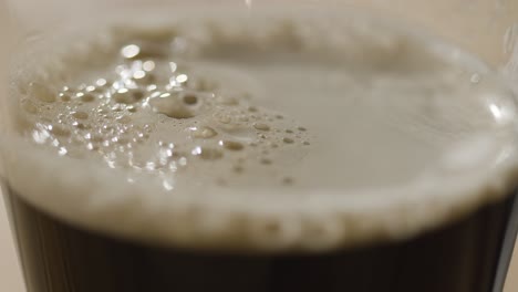 close up of pint of irish stout in glass to celebrate st patricks day 2