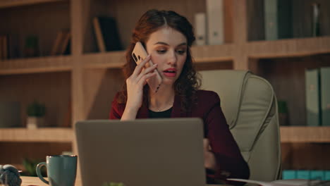 smiling financier talking cellphone looking on report at night office close up.