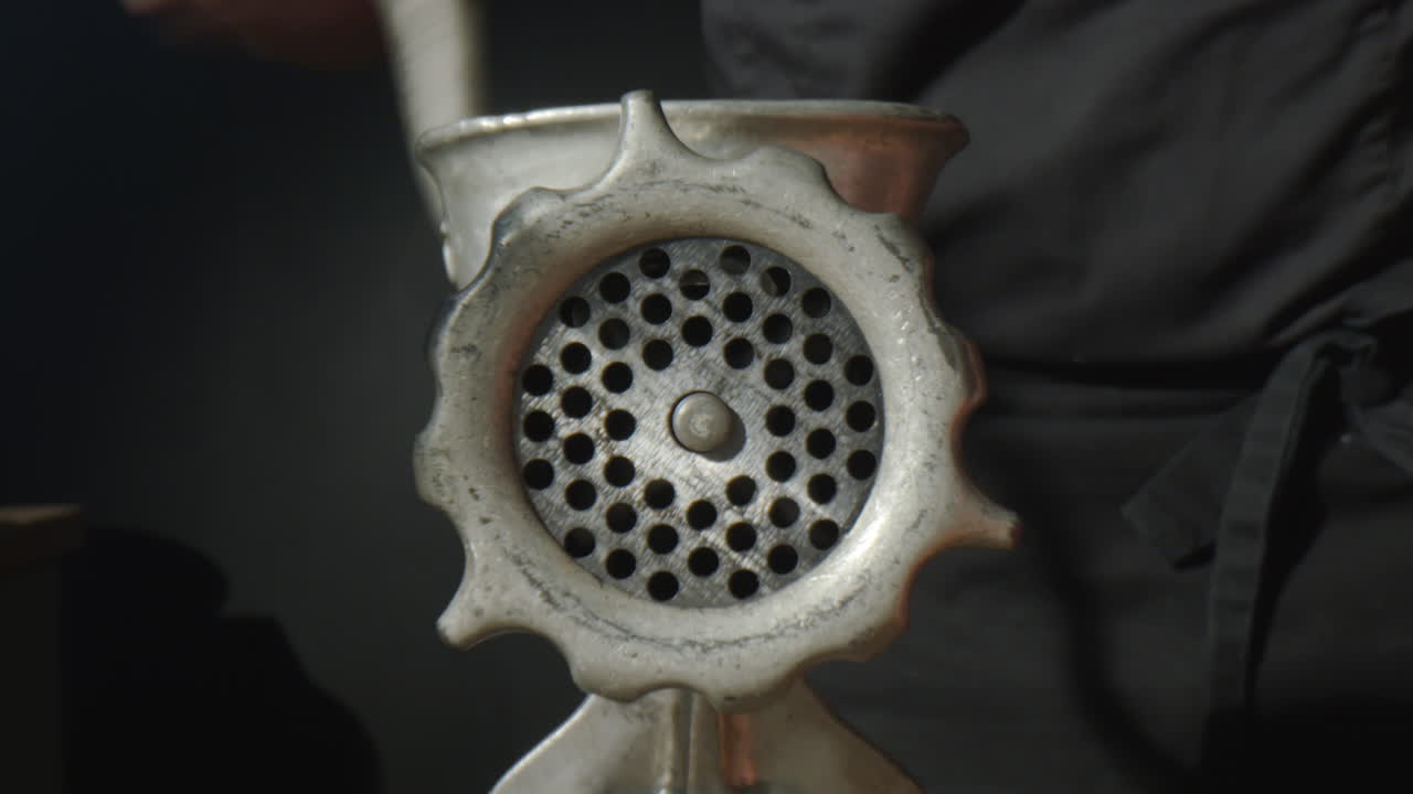 Man Using Manual Meat Grinder