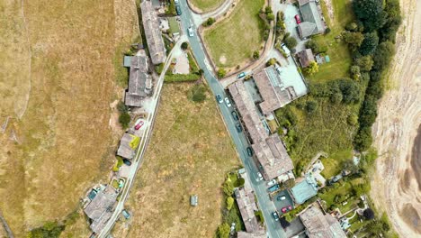 aerial footage of a rural industrial town village with old mill and chimney stack