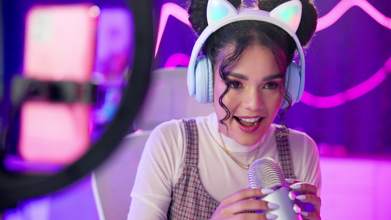 A woman streaming live with headphones and microphone