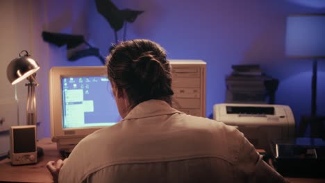 man working and gaming on retro computer pc, it engineer with vintage computer at home, using old fashion technology, close up of retro setup.