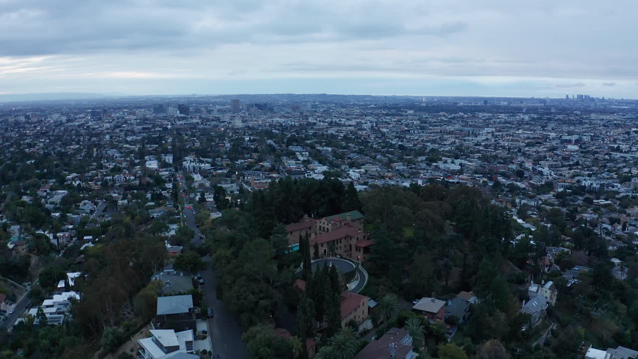 Aerial high and wide panning shot of the historic Paramour Mansion on a moody evening in Hollywood, California. 4K
