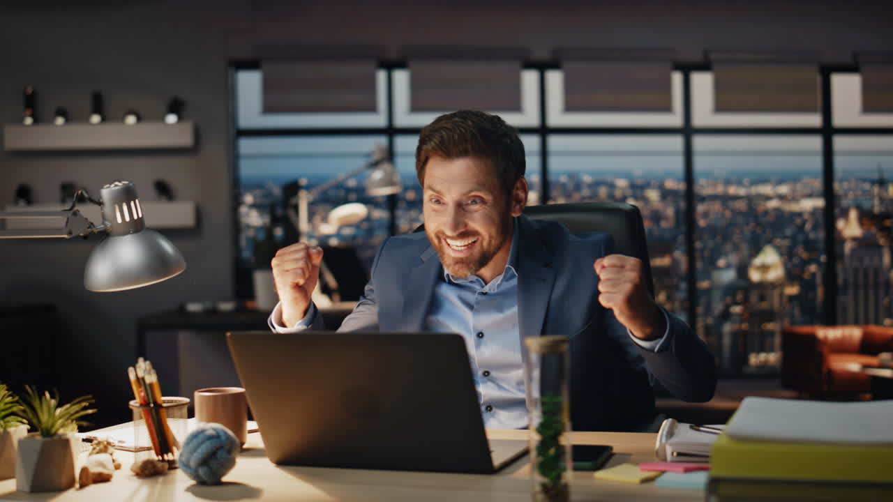 Happy winner rejoicing achievement evening office closeup. Man gesturing hands