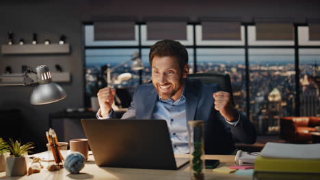 happy winner rejoicing achievement evening office closeup. man gesturing hands