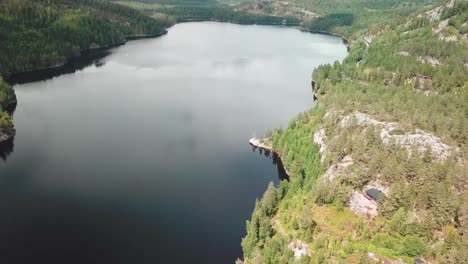 forward tilt down aerial shot over a lake surrounded by a forest