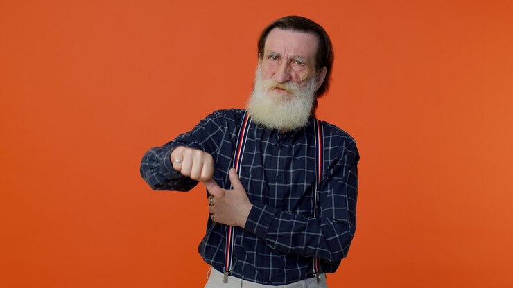 Upset elderly man showing thumbs down sign gesture, expressing, disapproval, dissatisfied, dislike