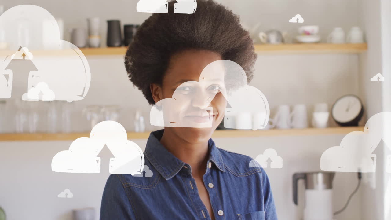 Animation of cloud icons over african american smiling