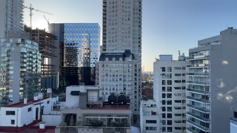 A-skyscraper-is-reflected-in-another-skyscraper,-high-rise-buildings-in-Buenos-Aires