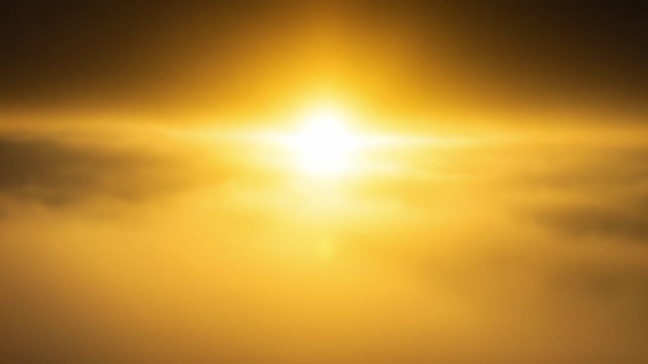 A Majestic Sunrise Breaking Through a Layer of Soft Clouds, Illuminating the Sky with Warm Golden Hues in a Stunning Display of Nature's Beauty and Tranquility