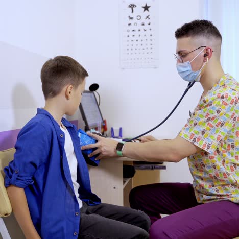doctor measuring blood pressure of a child in examination room. small kid with pediatrician