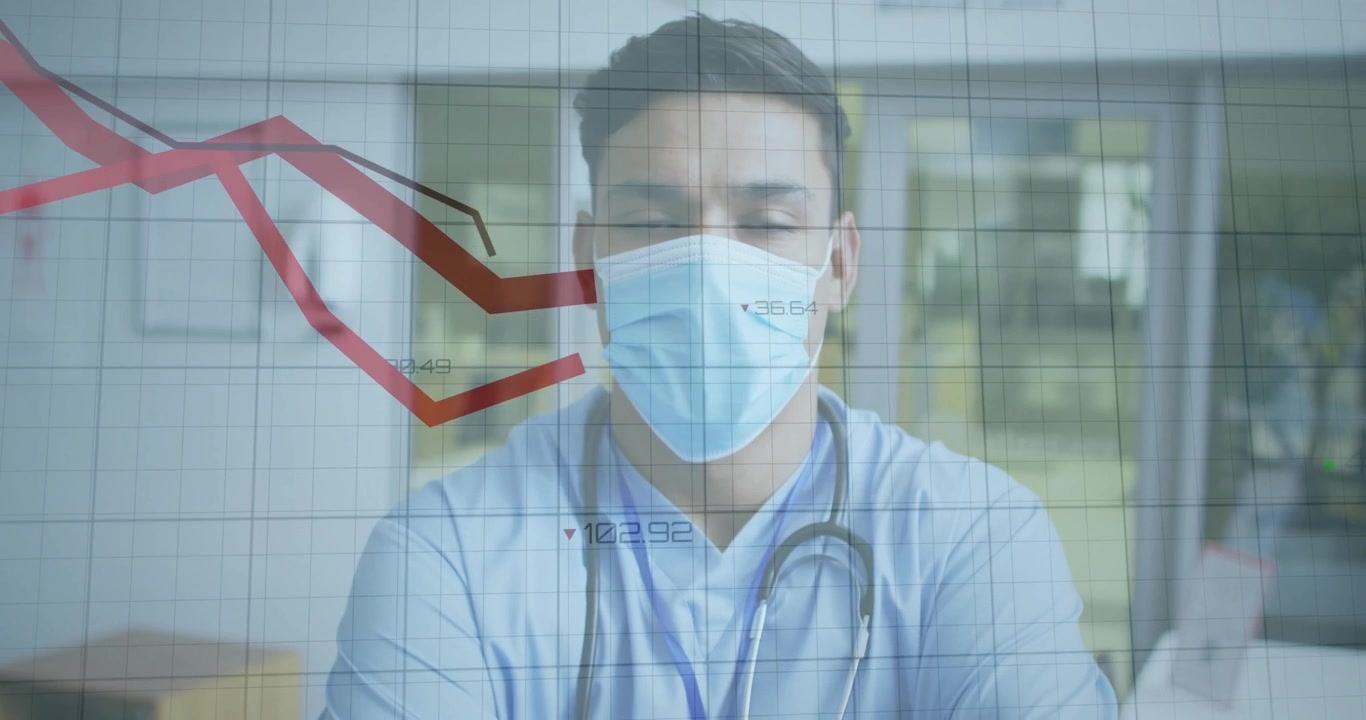 Profesional médico masculino monitoreando métricas en declive en un hospital, con una superposición de gráfico rojo descendente.