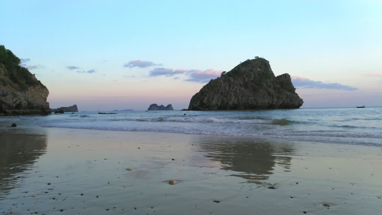 Beautiful evening sun at beach with unknown peoples having fun.
