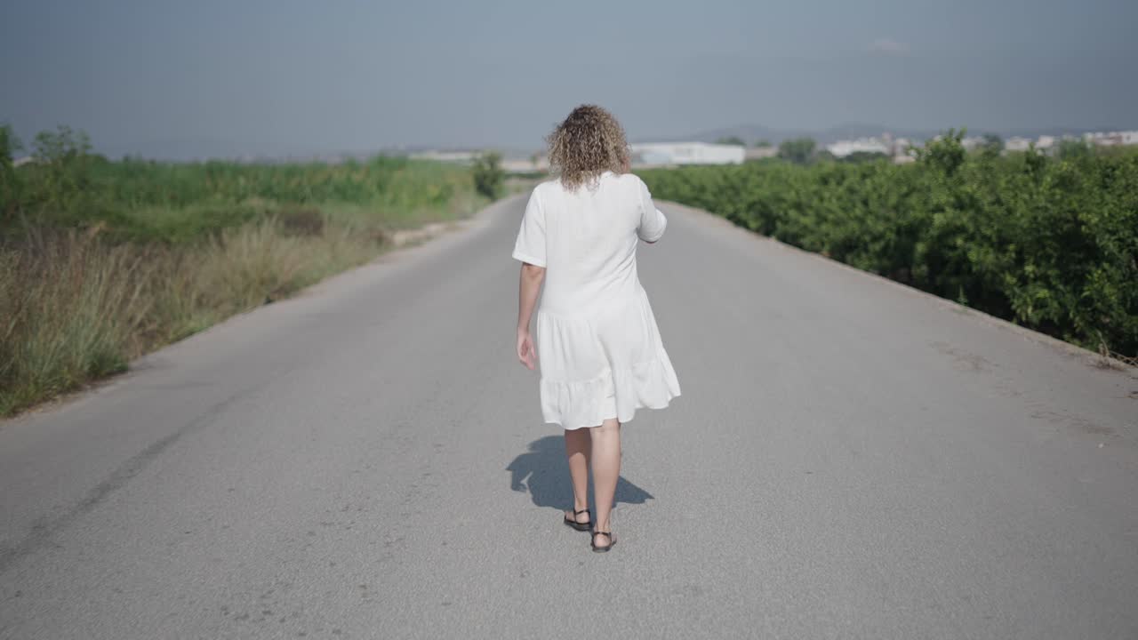 Woman Walking on Country Road