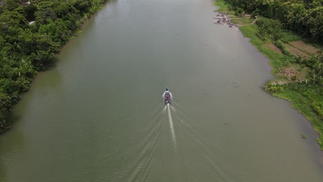 aerial view of a traditional boat running on the opak river, yogyakarta with a beautiful view