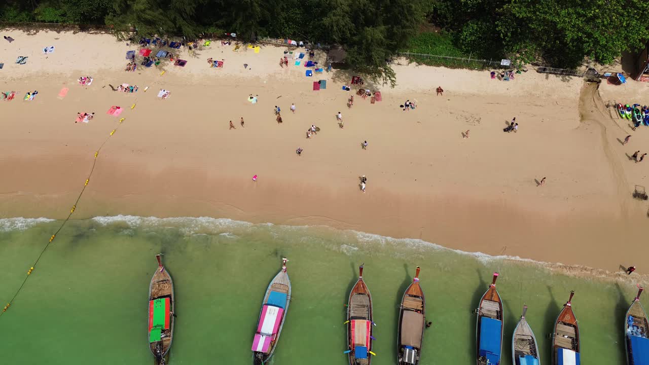 Traditional Thai longtail boats moored on Railay Beach Thailand, aerial drone view