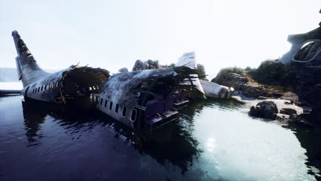 plane wreck on the beach with rocks near ocean