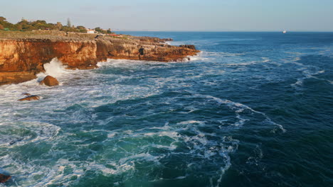 amazing coastal rocky scenery sunny summer day drone view. stormy ocean foaming