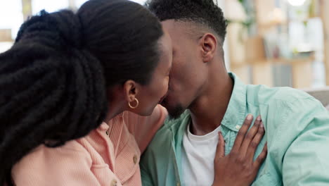 love, happy and black couple kissing on a sofa