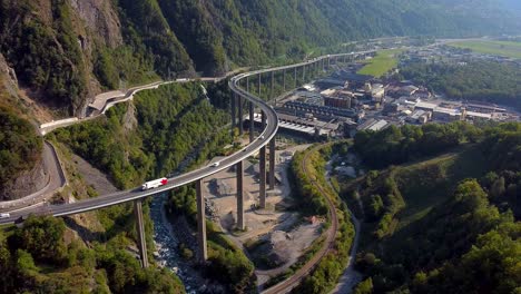 aerial locked shot of an industrial area and huge bridge in the mountains