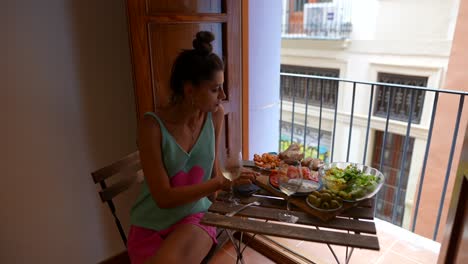 woman enjoying a meal on a balcony