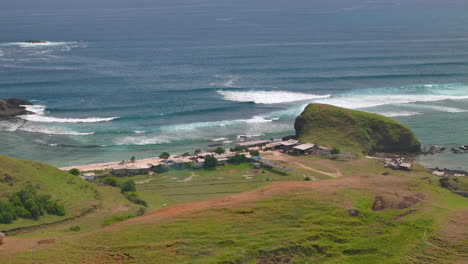 lombok coastline near kuta and seger beach gerupuk with waves crashing on the shore, aerial view