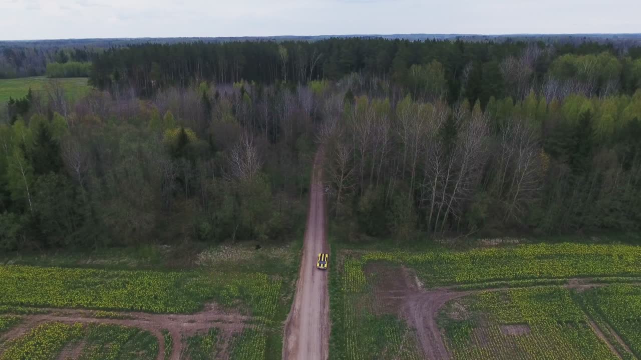 Yellow With Black Stripes Classic Ford Consul Rides To A Forest. 4K Aerial Footage