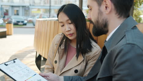 Business Colleagues Reviewing Documents Outdoors