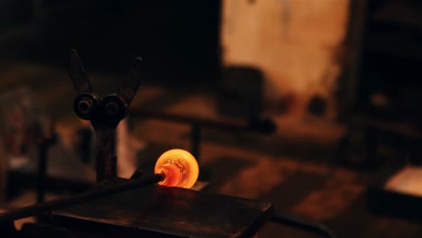 Close-up-of-molten-glass-being-shaped