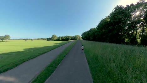 Smooth-follow-various-angles-immersive-camera-changing-angles-and-perspective-showing-a-male-trail-runner-on-floodplains-valley-dyke