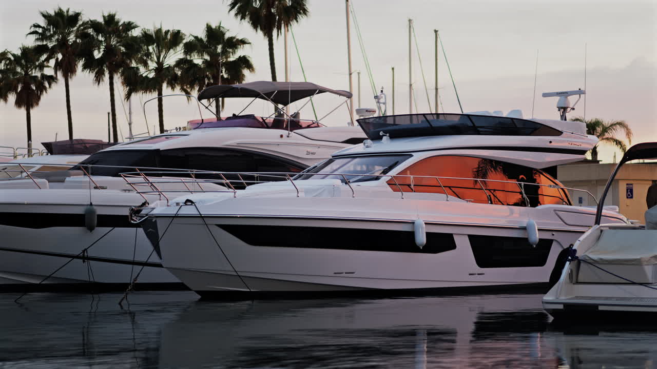Antibes, France - May 8, 2025: Multiple white boats docked in the Port Vauban at sunset