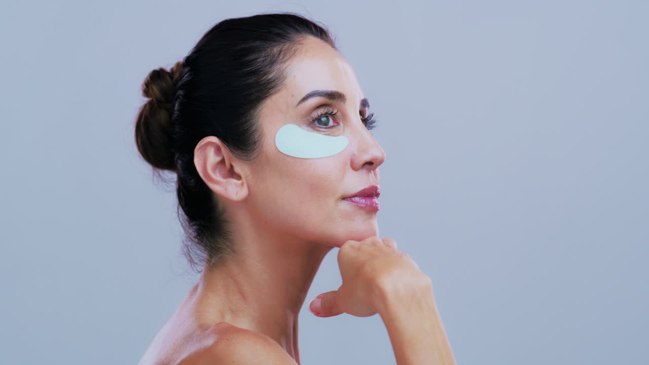 Woman with eye patches for skin care