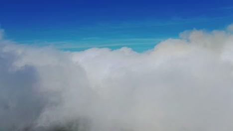 scenic view of beautiful sky. flying among soft white clouds moving on blue sky. high in blue sky through the fluffy clouds.