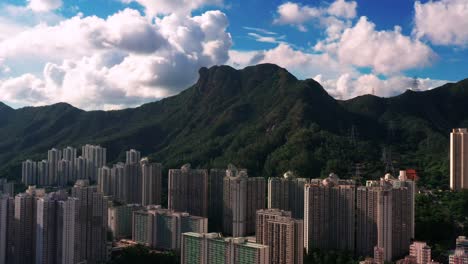 kowloon landmark lion rock downtown skyscraper city mountain landscape aerial view orbit right